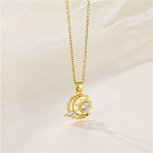 Detail of gold moon and sun pendant necklace set with clear cubic zirconia crystals