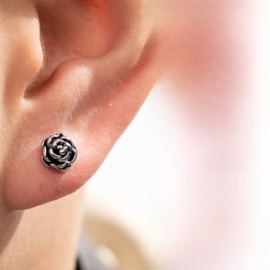 Detailed view of vintage silver steel rose stud earring with intricate petal engraving