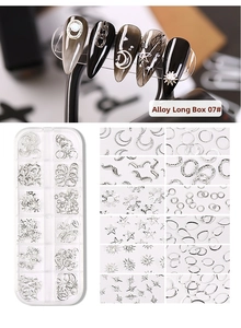 Macro view of silver nail alloy charms set with moon and star shapes in a 12-slot case