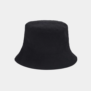 Close-up of the textured black corduroy fabric and stitching on a reversible bucket hat