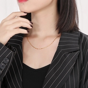 Elegant gold lip chain necklace for women, stylish wave link choker shown on model