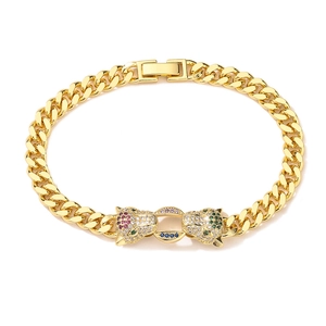 Macro detail of gold Cuban link bracelet featuring a double leopard head with zircon stones