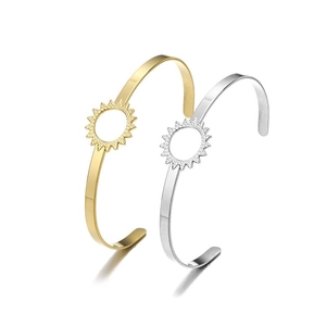 Detailed view of polished stainless steel open bracelets with sunburst cutout design
