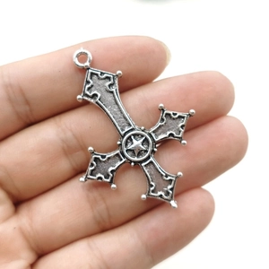 Detail of gothic inverted cross pendant with pentagram star held to show size