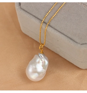 Close-up of a Baroque freshwater pearl pendant on a S925 silver gold clasp