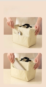 Detail of front storage pocket on beige lunch bag for utensils and phone
