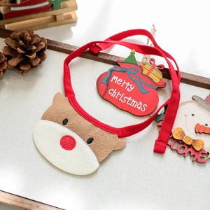 Detail of red felt reindeer Christmas dog bandana with festive holiday decor