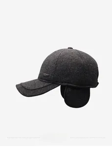Close-up of winter baseball cap with knit texture, ear flaps, and stitched brim
