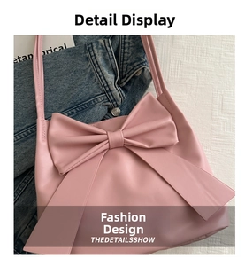 Detail of soft pink tote bag with oversized decorative bow and thin shoulder strap