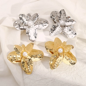 Chic oversized metallic flower earrings with irregular petals and central pearl accents