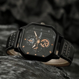 Fashionable men's square quartz watch with black leather strap on dark rock background