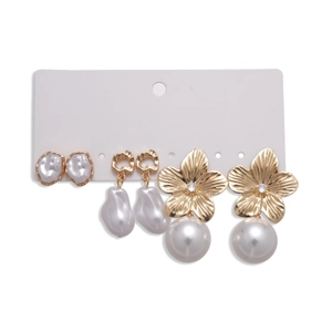 Set of 3 pairs golden floral and heart earrings with imitation pearls on white card