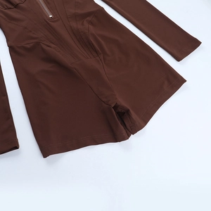 Close-up of brown bodycon jumpsuit with front zipper detail and sleek seam lines