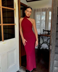 Detail of burgundy backless halter evening dress showing its slim fit and flowing fabric