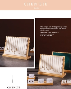 Detail of bamboo wood necklace display board with multiple slots and soft textured lining