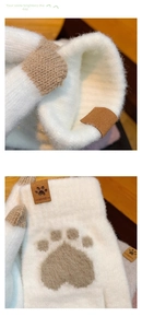 Detail of warm white knit gloves featuring soft faux mink fur and cute paw pad patterns
