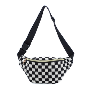 Close-up of black and white checkered waist bag with gold zipper and adjustable buckle strap