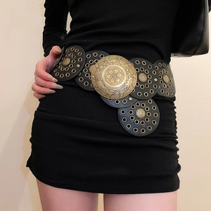 Detail of vintage bohemian waist belt with bronze metal studs and embossed round medallions
