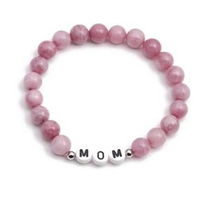 Pink agate beaded bracelet featuring white MOM letter beads and silver spacers on white base