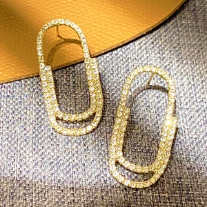 Sparkling pave set double oval hoop earrings in golden finish with white zircon stones