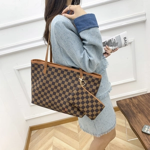Brown checkerboard tote bag set with matching coin purse shown on a fashion model