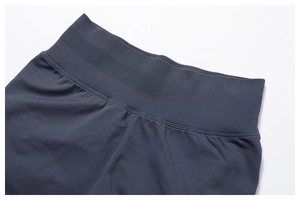 Macro detail of high-waisted ribbed waistband on seamless dark blue yoga leggings