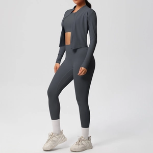 Three-piece charcoal yoga set including zip-up jacket, crop top, and high-waist leggings