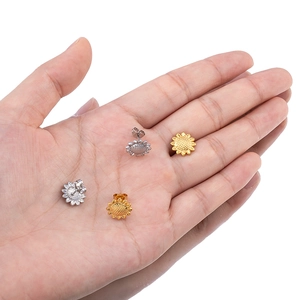 Sunflower stud earrings in gold and silver finish shown on a palm for size comparison