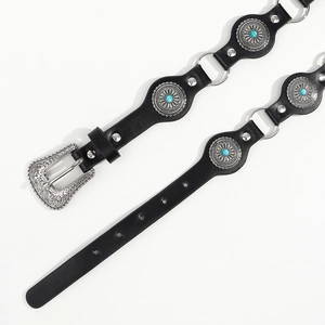 Detail of vintage punk belt with turquoise inlay and ornate silver buckle craftsmanship