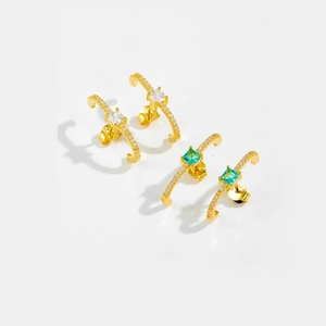 Detailed macro view of S925 silver gold-plated stud earrings with square green and white zircon