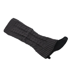 Detail of dark grey cable knit leg warmers with thick ribbed cuffs and wool texture