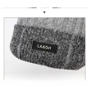 Close-up of grey knit beanie with thick rib texture and LA&DH logo patch
