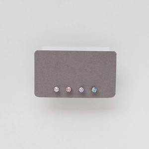 Close-up of four pairs of titanium steel birthstone stud earrings in various colors