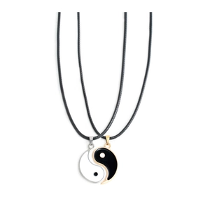 Detailed view of black and white Tai Chi Yin Yang pendants with leather cord