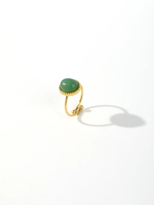 Detailed view of the vintage gold stainless steel ring with an oval green stone inlay