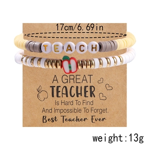 Detail of TEACH alphabet beads bracelet with apple charm on kraft display card