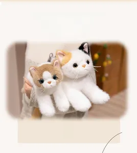 Close-up of realistic plush kittens with soft faux fur in calico and ginger white colors