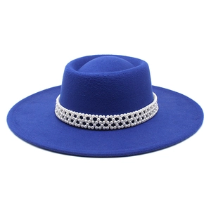 Close-up of royal blue wool fedora featuring an elegant white pearl beaded hatband