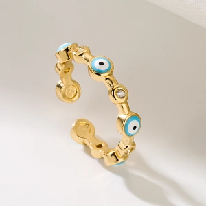 Adjustable gold plated evil eye ring with blue enamel and cubic zirconia accents