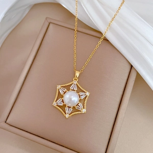 Macro detail of gold hexagon star pendant with white pearl and sparkling zircon stones