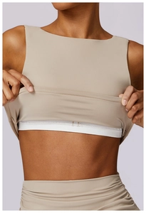 Detail view showing high-impact shockproof inner lining of beige yoga sports bra