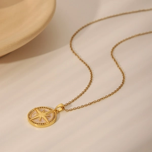 Elegant gold chain necklace with an eight-pointed star pendant and small crystals inlay