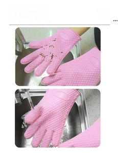 Close-up showing easy water cleaning of pink silicone heat resistant kitchen gloves