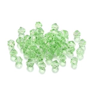 Macro detail of faceted grass green bicone glass crystal beads for DIY jewelry making