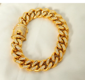 Macro detail of 18k gold plated Cuban link bracelet featuring white zircon stone pavé setting