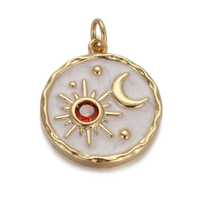 Detail of round gold pendant featuring white enamel with sun crescent moon and star patterns