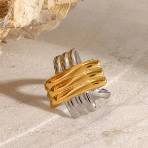 Detail of cross-textured stainless steel ring with two-tone gold and silver finish