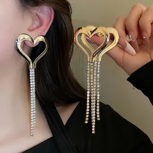 Silver needle heart fringe earrings with gold mirror finish and long rhinestone tassels