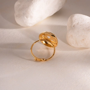 Detailed view of the gold adjustable ring with an elegant hollow heart circle design