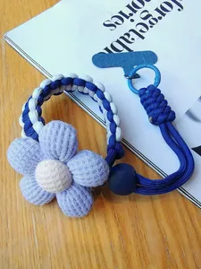 Detail of woven phone lanyard featuring blue-white rope and purple waffle texture flower